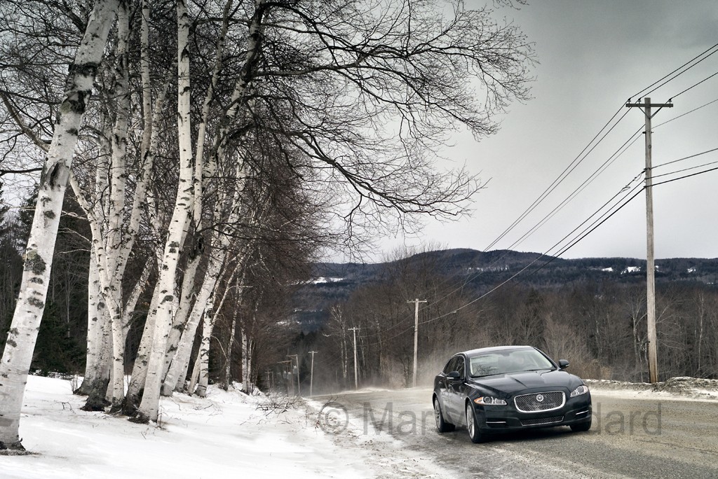 Jaguar XJ AWD driving on a winter road in Vermont USA