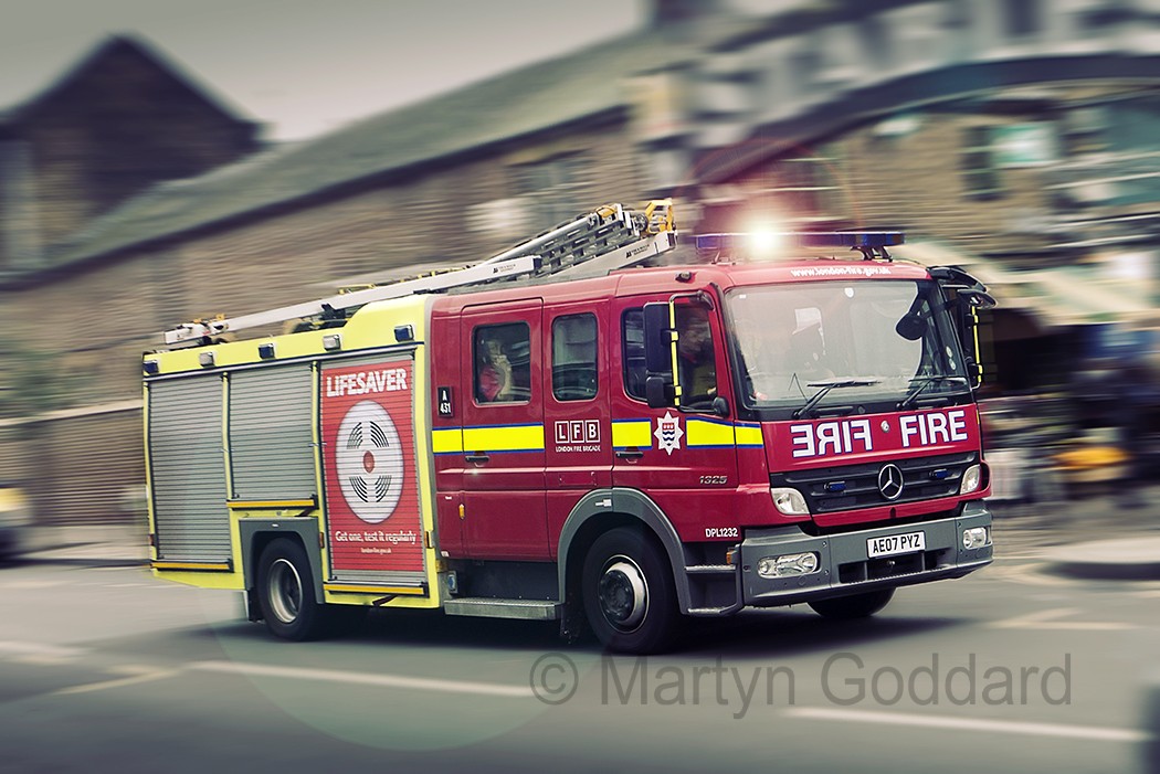 London Fire Brigade Mercedes-Benz Fire engine at speed in Camden town London UK
